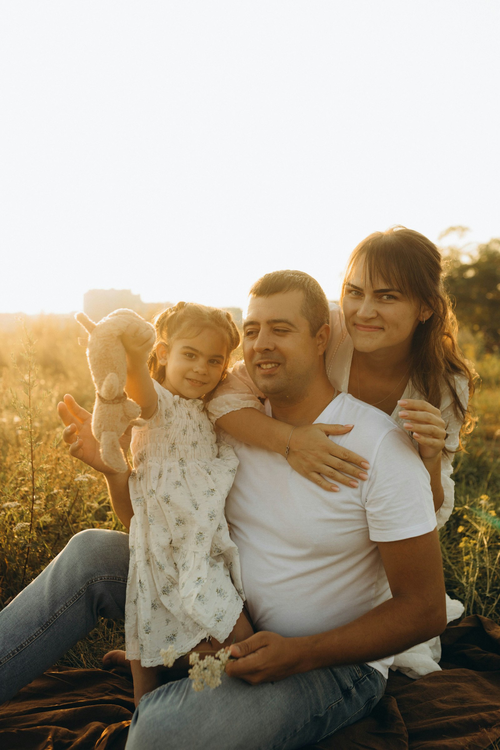 Family gathered together in a sunlit field